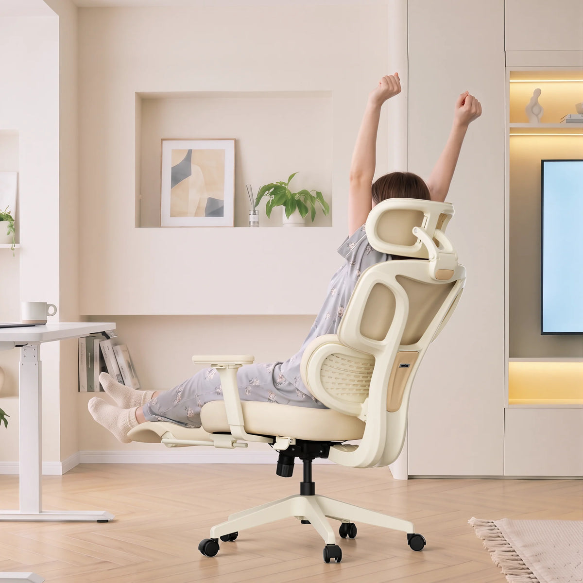 Cream ergonomic office chair with mesh back, headrest, armrests, and footrest