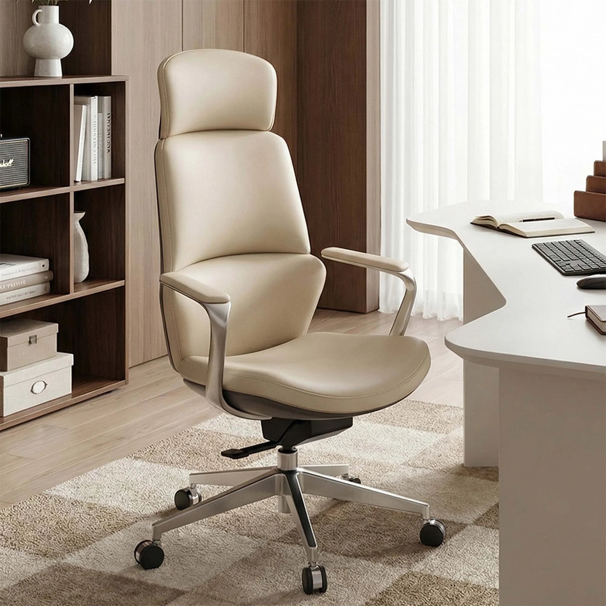 Beige leather office chair with tall back and curved arms on rolling casters.