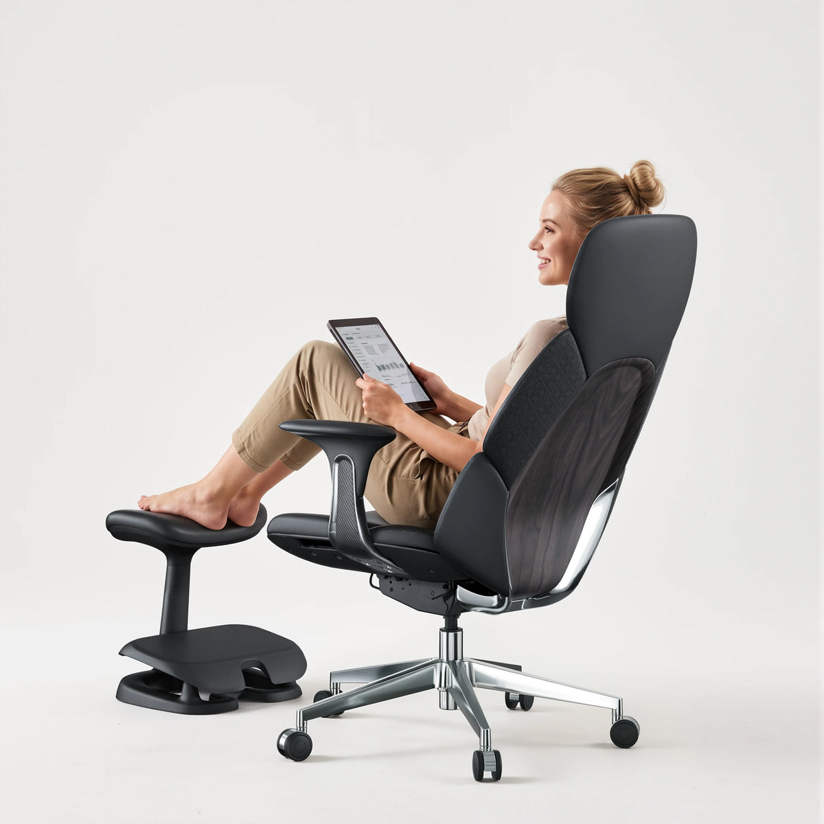 Black Welax footrest supporting a seated person's feet