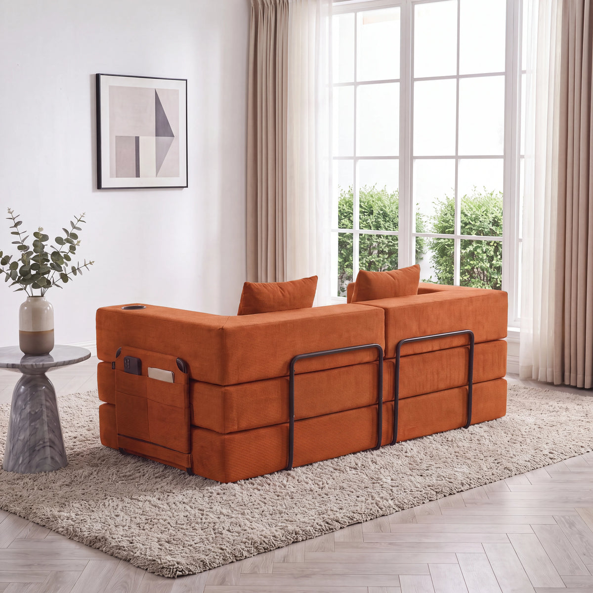 Orange modular sofa with built-in ottoman storage and protective back rails