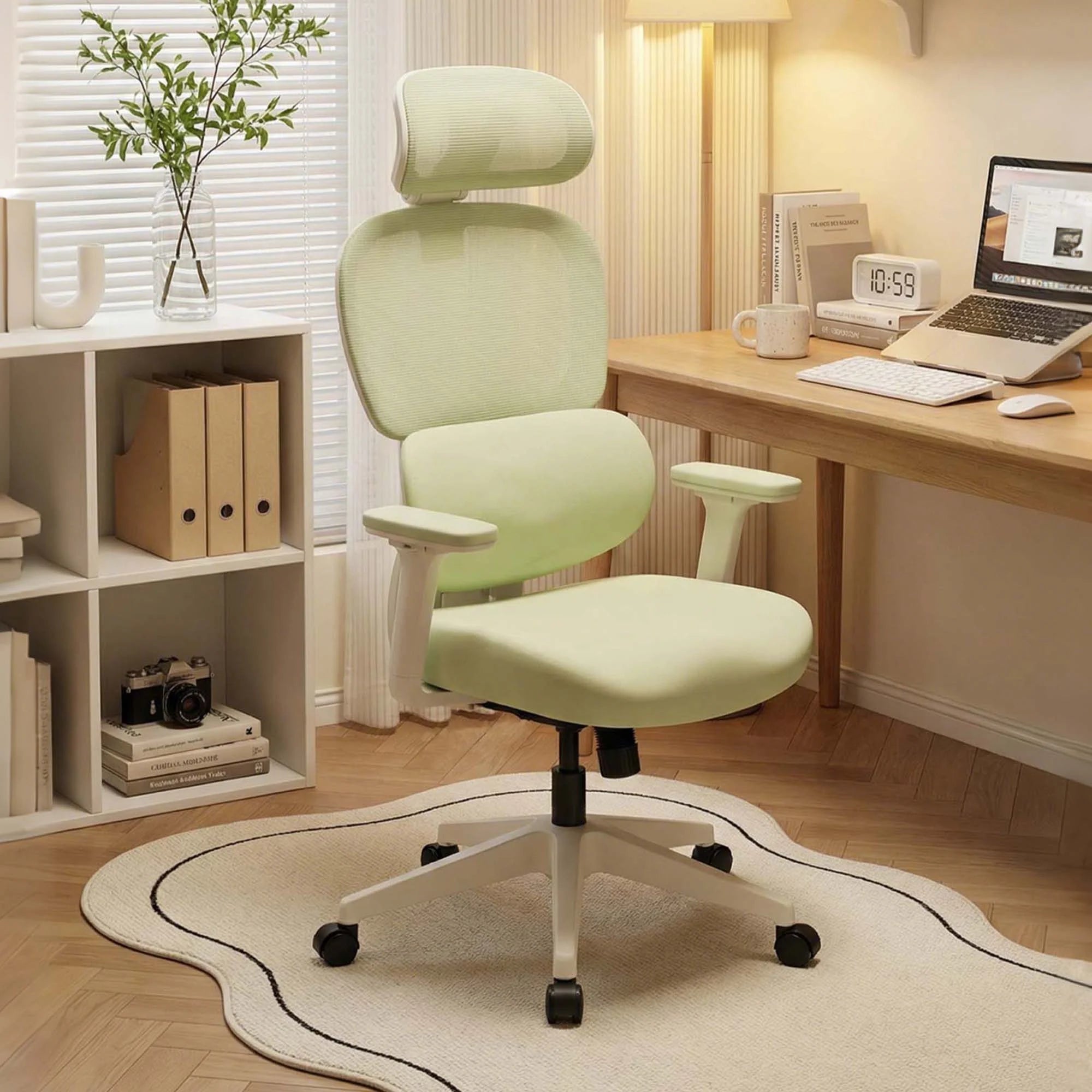 Light green office chair with cushioned seat, armrests, and attached footrest ottoman