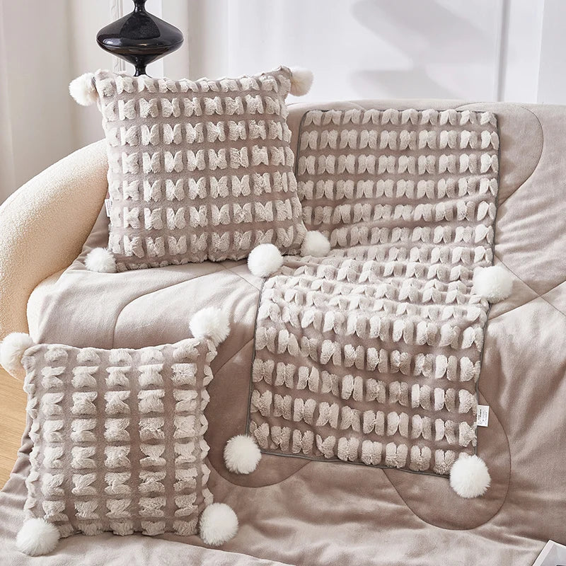 Plush throw pillow set with hidden blanket, light beige woven pillows with pom-poms
