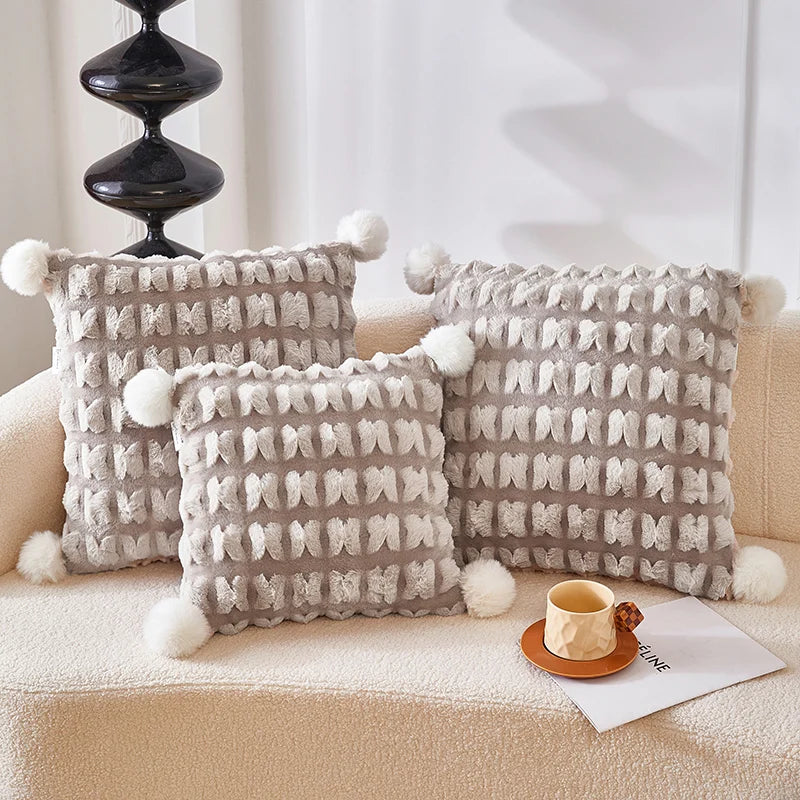 Plush throw pillow set with hidden blanket, light beige woven fabric and pom-pom trim