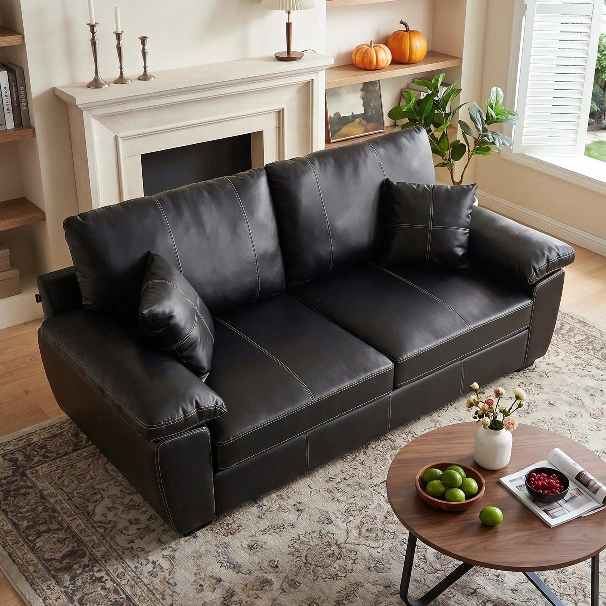 Black leather-look loveseat with tufted back cushions and thick padded arms