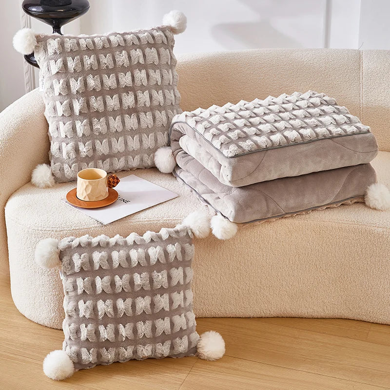 Plush throw pillow with hidden blanket, light beige woven pillows and folded blanket