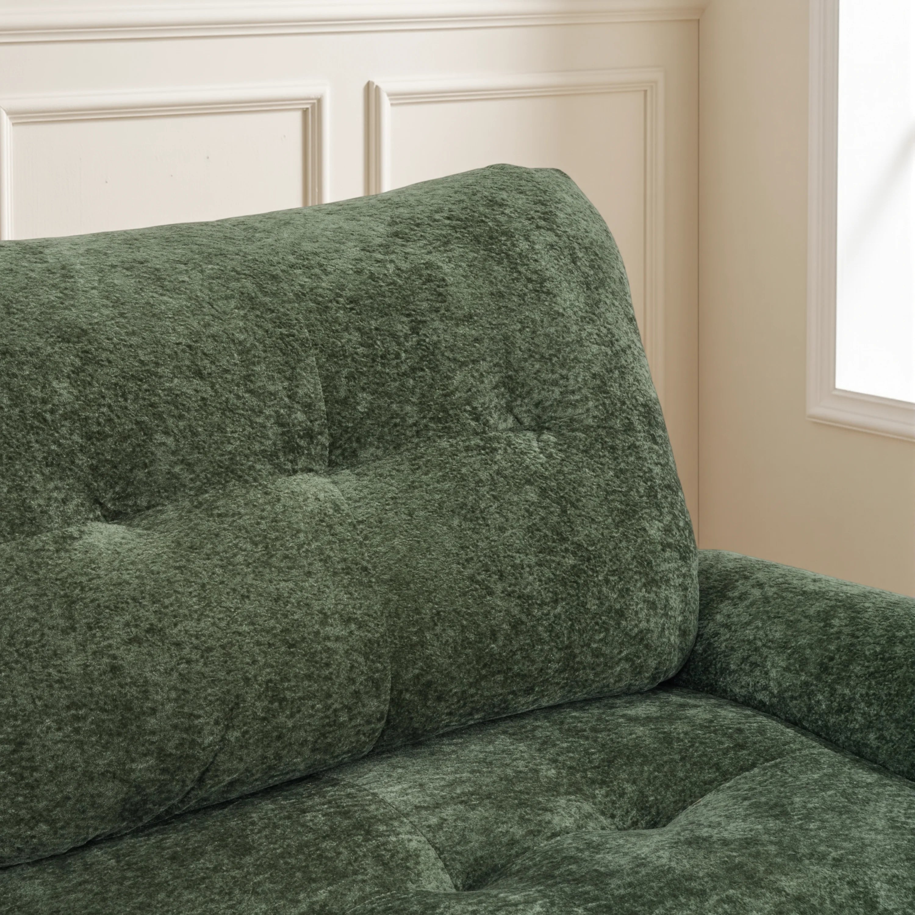 Green deep-seat plush sofa with rounded arm and textured upholstery