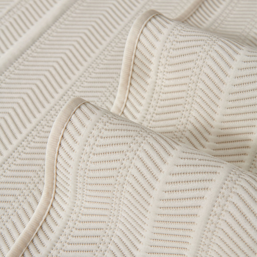 Sofa pad set fabric close-up: cream cover with tonal zigzag pattern and rounded edge trim