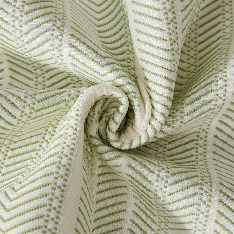 Sofa pad set fabric close-up: white cloth with green dotted zigzag lines, folded texture