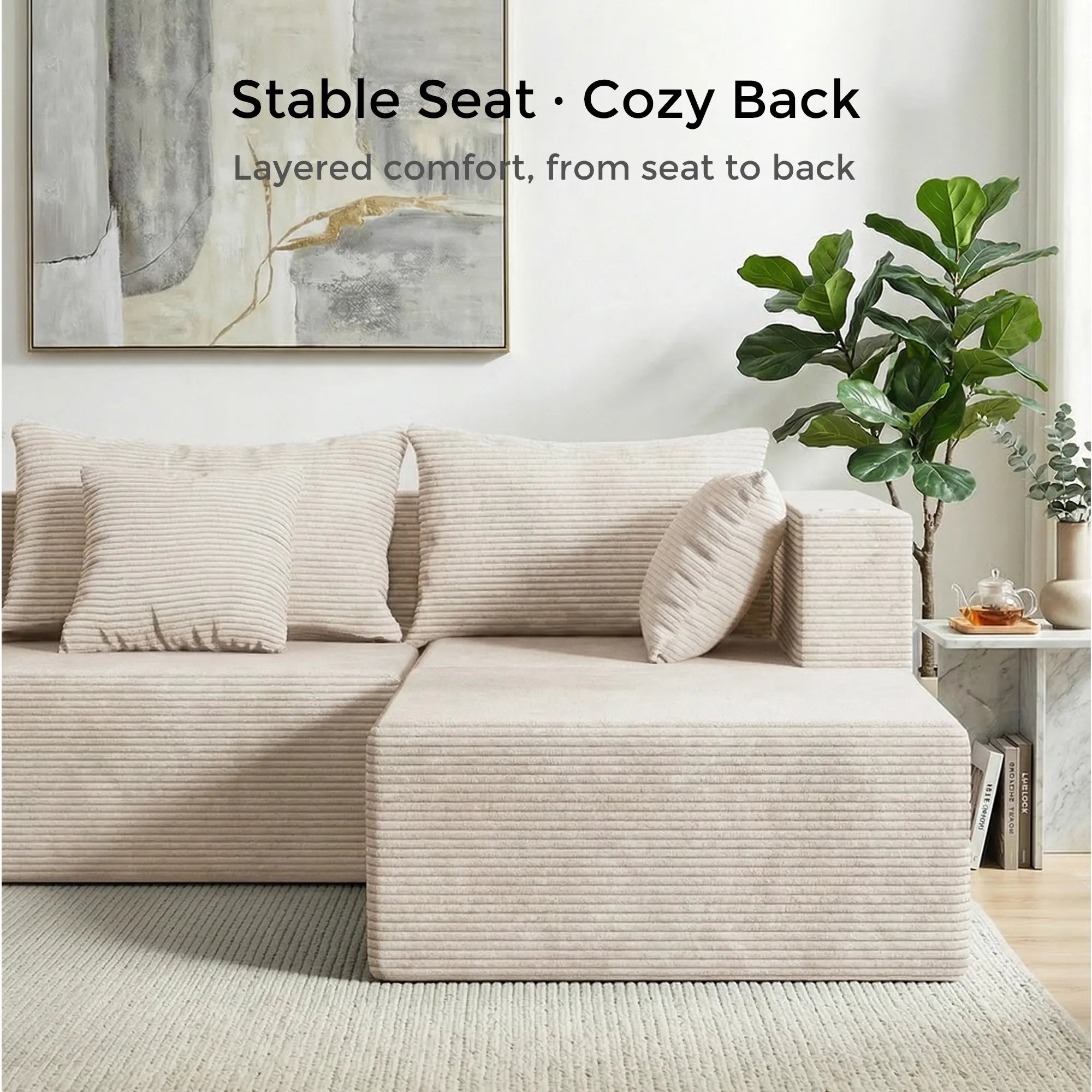 Cream modular sectional sofa with layered back cushions and chaise ottoman