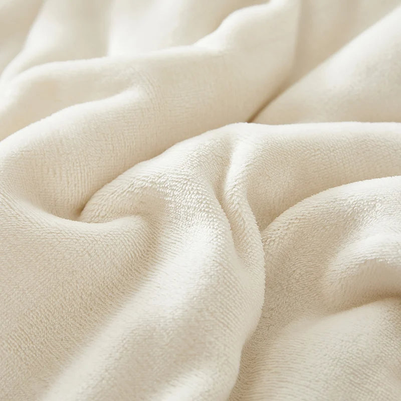 Cream plush throw blanket with soft textured fabric surface