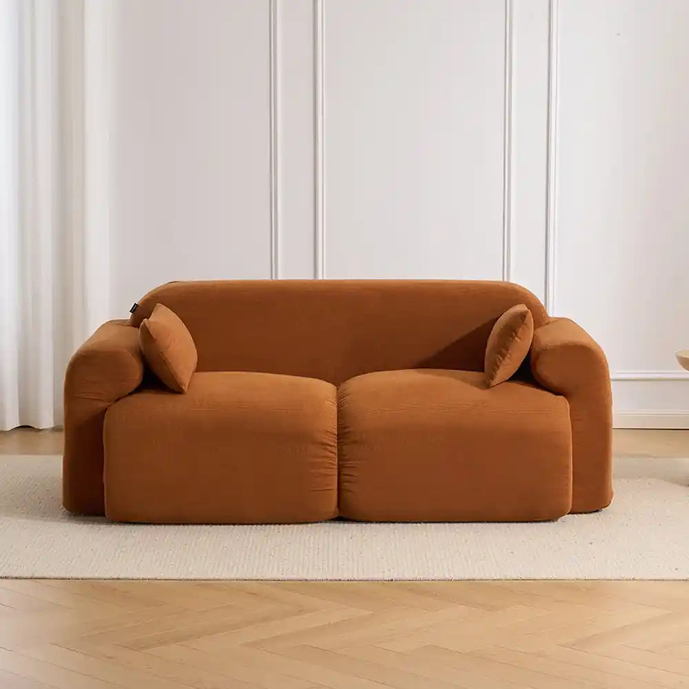 Burnt orange corduroy loveseat sofa with two bolster back cushions and padded seat