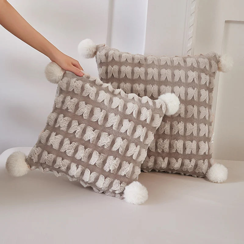 Plush throw pillow with hidden blanket, light beige woven pillows with pom-pom fringe