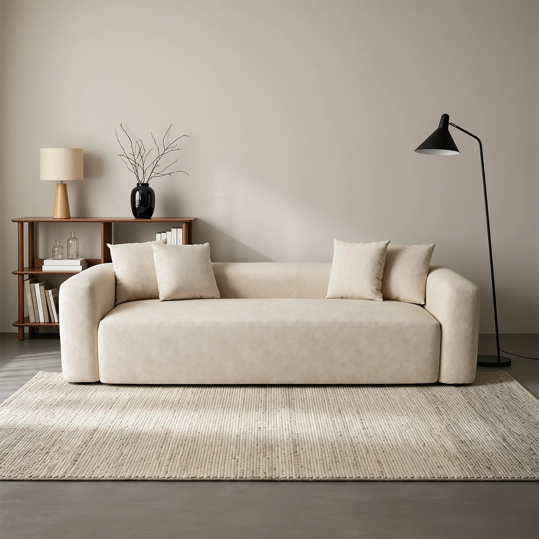 Cream minimal one-piece sofa with rounded arms and multiple back cushions