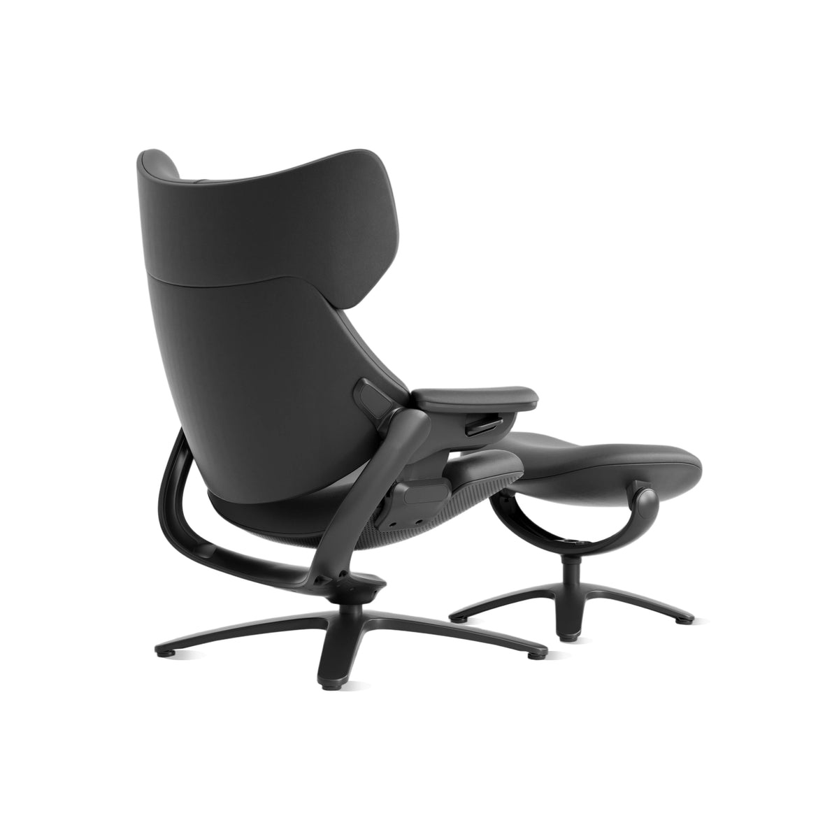 Black recliner lounge chair with attached ottoman, curved headrest and armrest.