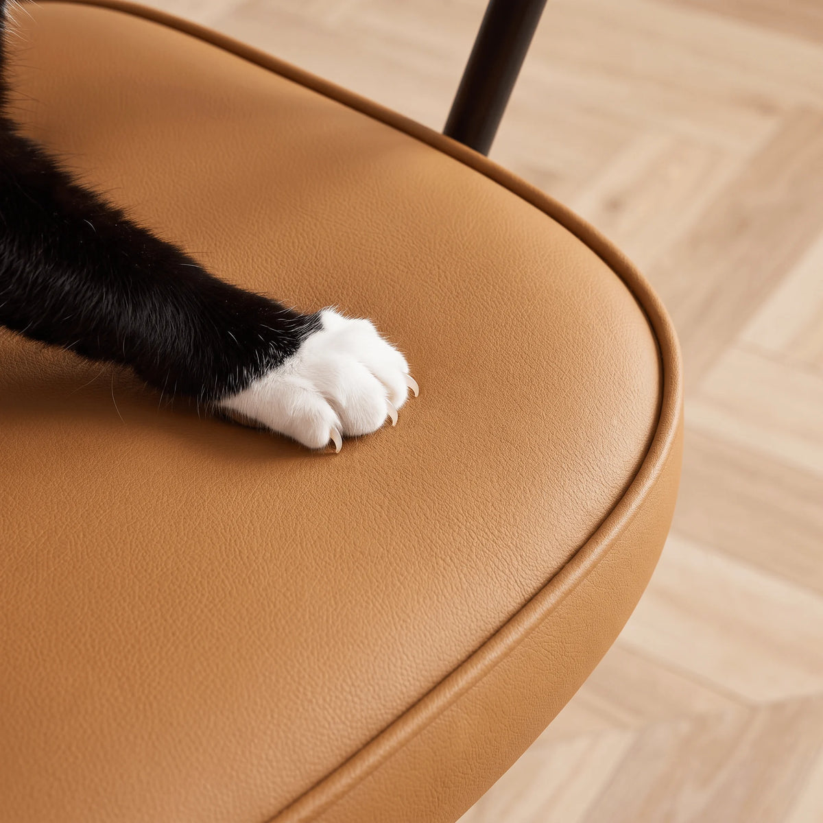 Close-up of burnt orange faux leather seat with tufted texture