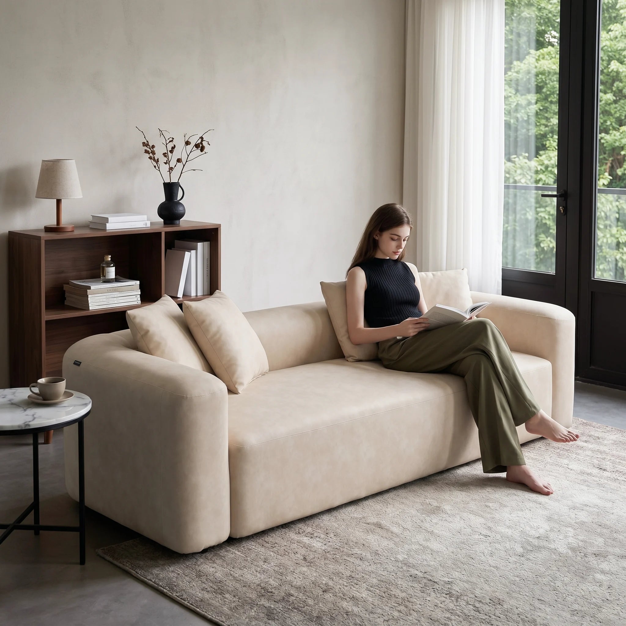 Cream minimal one-piece sofa with two back pillows and rounded armrests