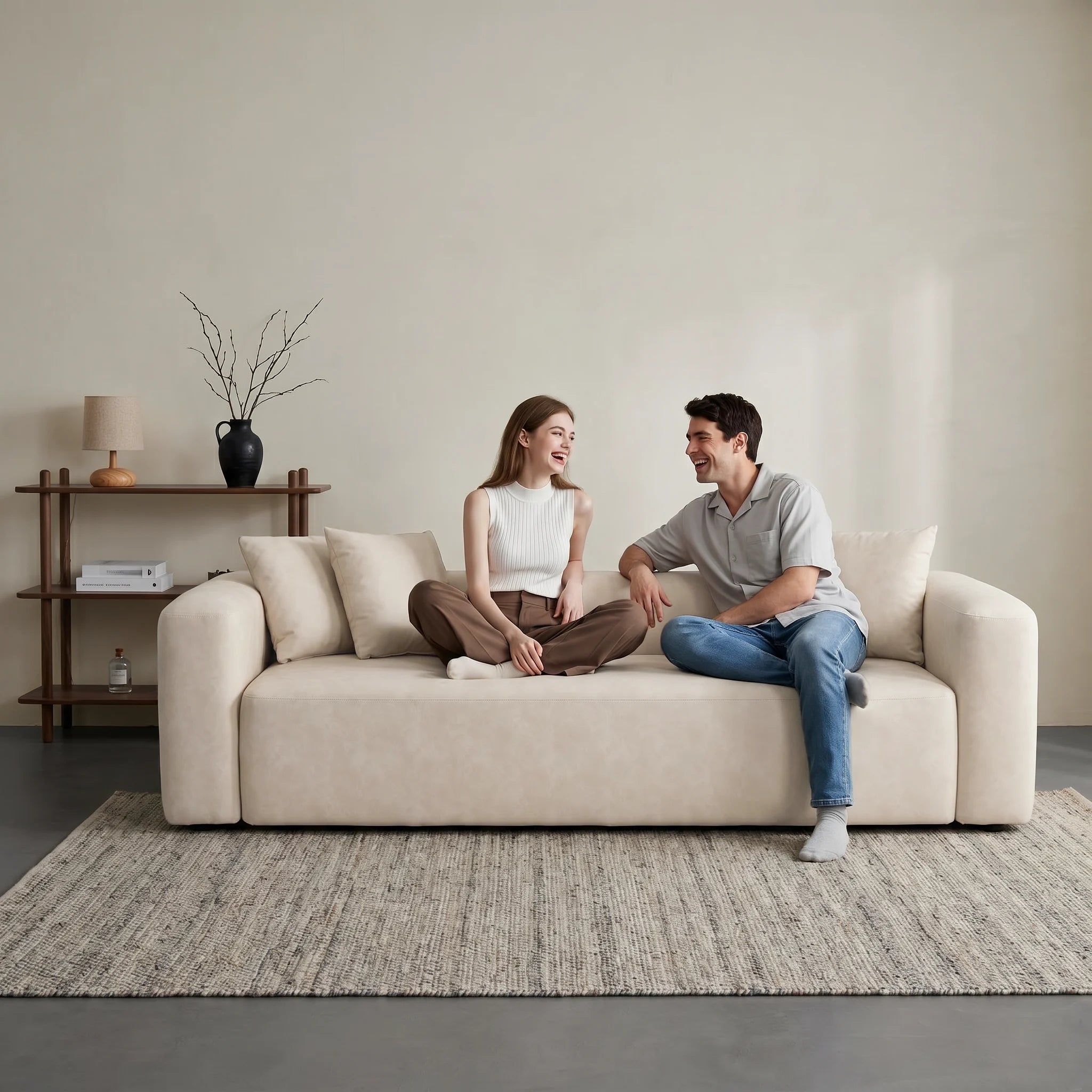 Cream minimal one-piece sofa with squared arms and two back cushions.
